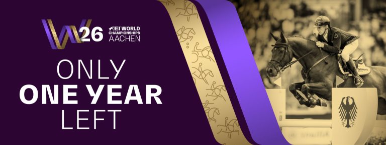 Graphic with the slogan ‘Only one year left’ and the logo ‘FEI World Championships Aachen 2026’ on a dark purple background. On the right is a rider with a horse jumping over an obstacle with the German eagle, the image is in a gold colour. Golden and violet graphic elements and stylised silhouettes of riders adorn the centre of the graphic.