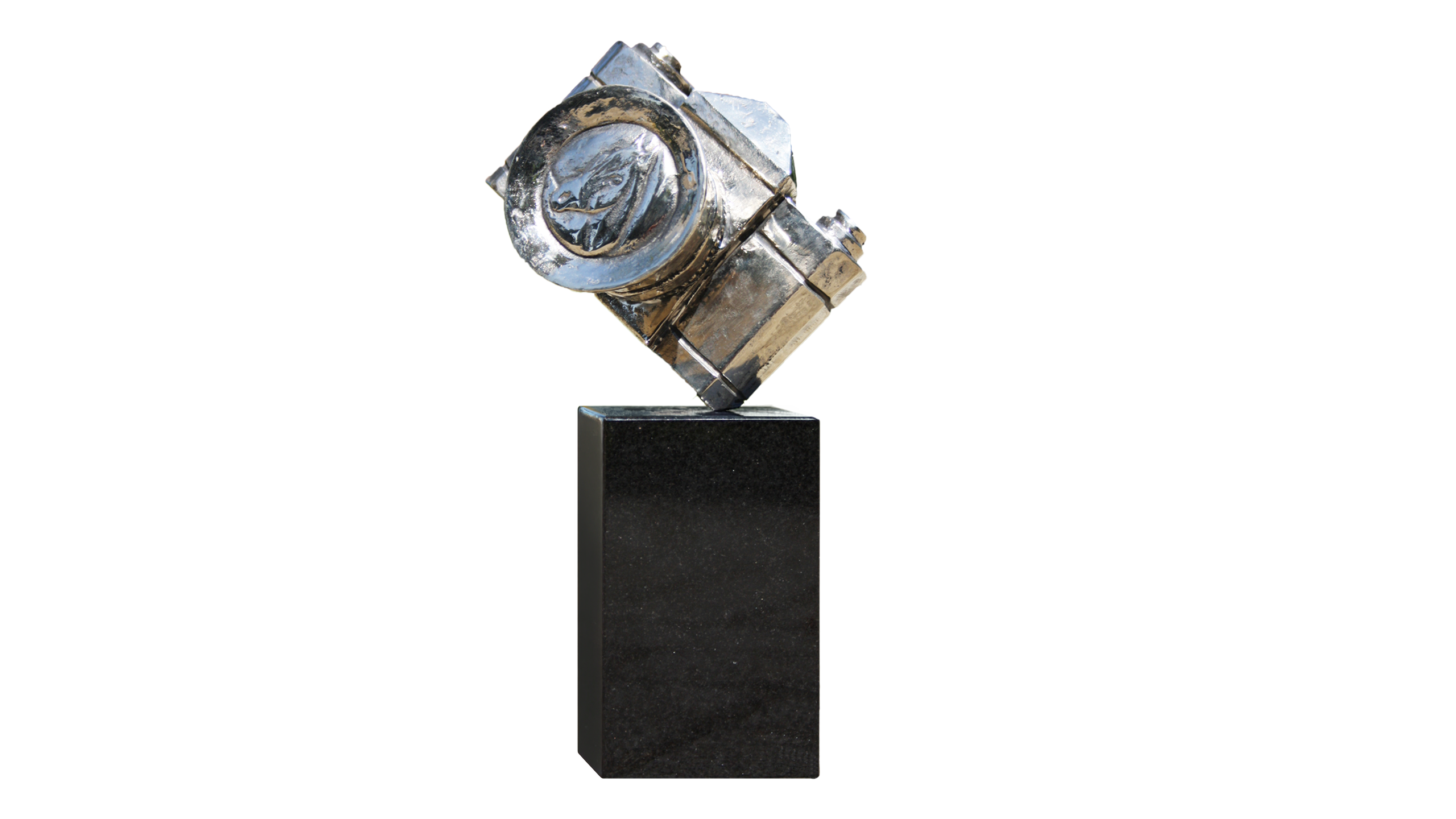 A silver, stylised camera sits at an angle on a black, rectangular base against a white background.